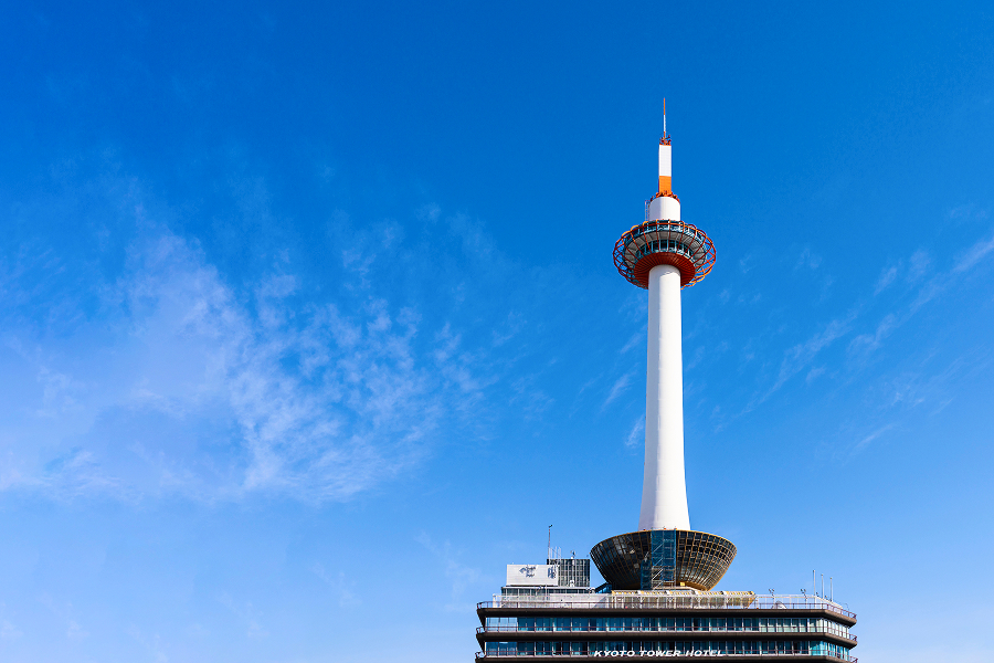 Kyoto Tower viewed from directly below under a blue sky