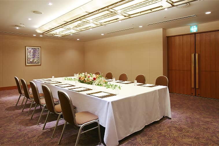 Interior view of a venue with tables set for a small number of people.