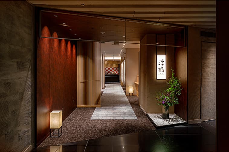 The interior of the Japanese restaurant features a corridor and entrances Private Room that evoke a sense of traditional Japanese aesthetics.