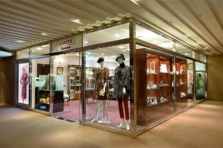 The bright exterior of the accessory shop features shelves and glass display cases.