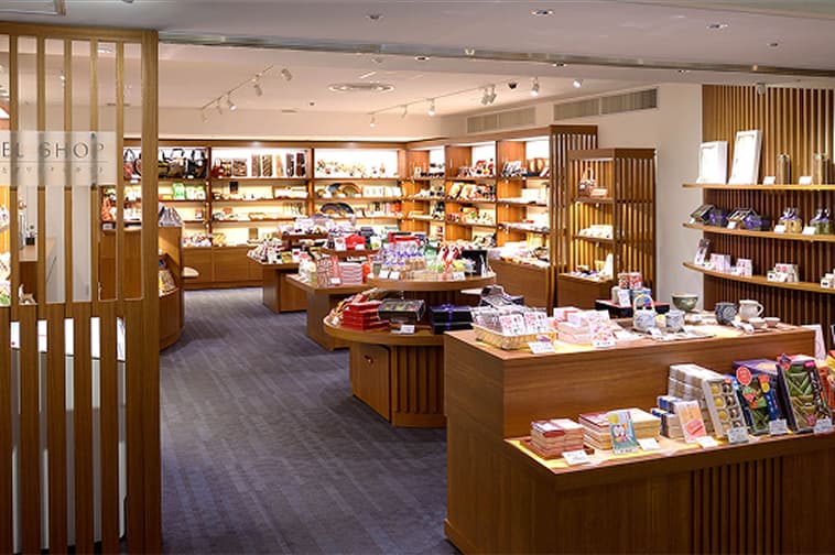 The hotel shop has a calm atmosphere with rows of souvenirs and merchandise shelves.