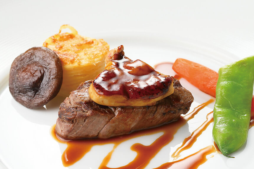A French steak topped with foie gras.