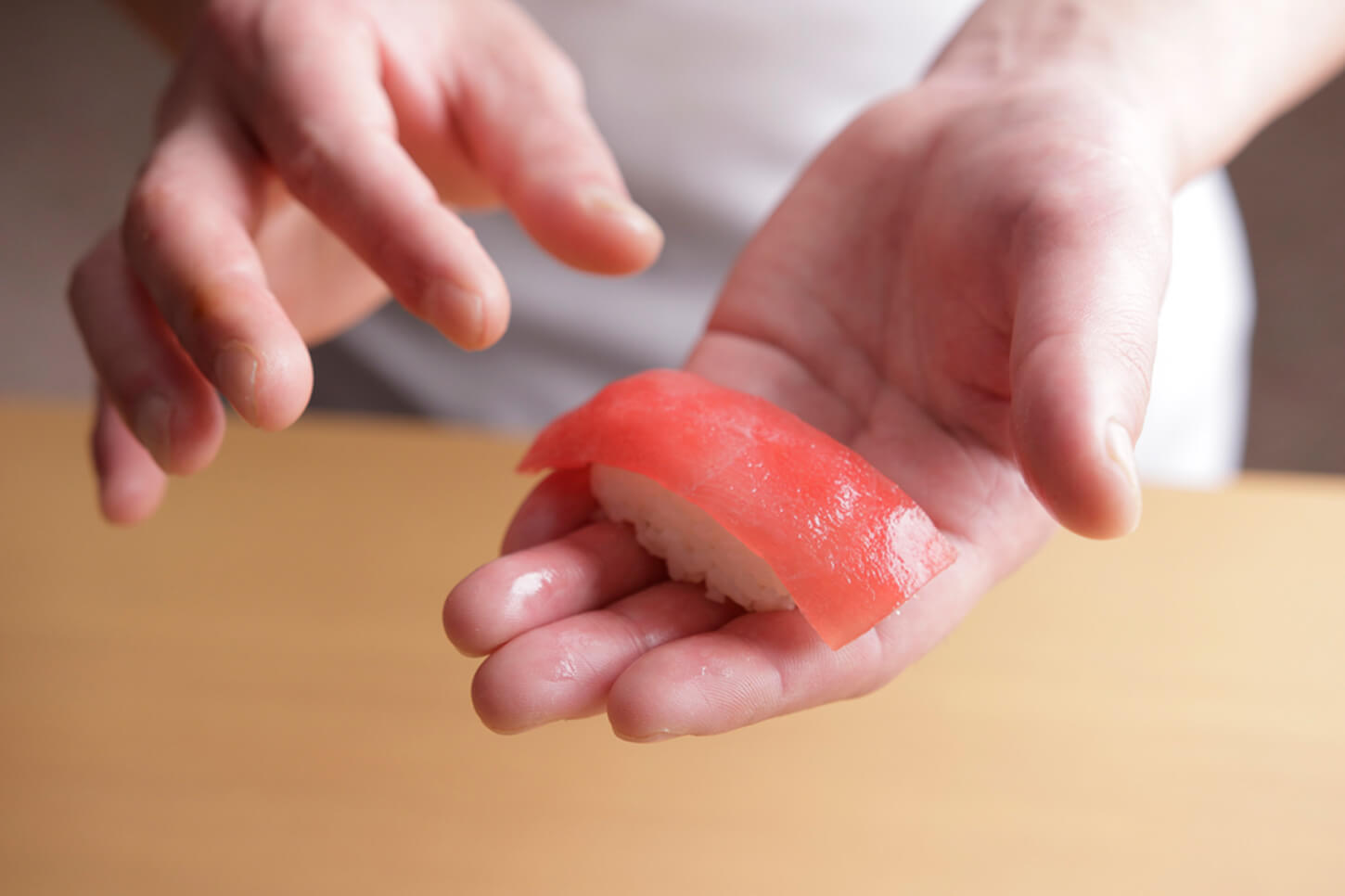 The artisan's hands and tuna nigiri sushi