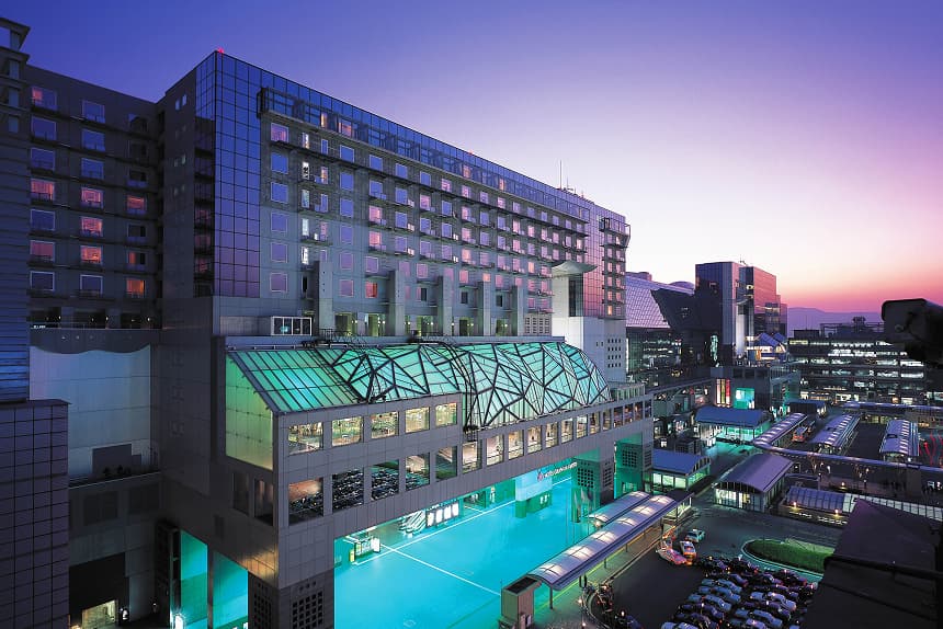 The exterior of Hotel Granvia Kyoto. The building is adjacent to Kyoto Station at dusk.