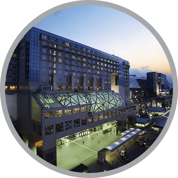 The illuminated Kyoto Station building and the hotel exterior