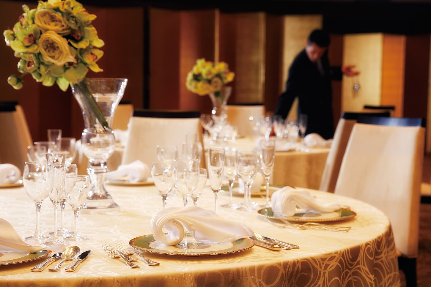 Table setting and floral arrangements for the banquet hall