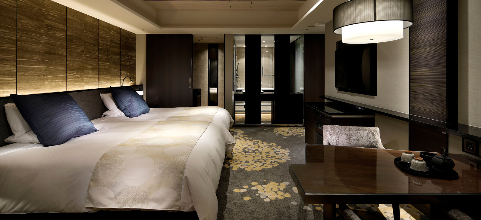 A luxurious Twin room with striking wood-grain walls and blue cushions.