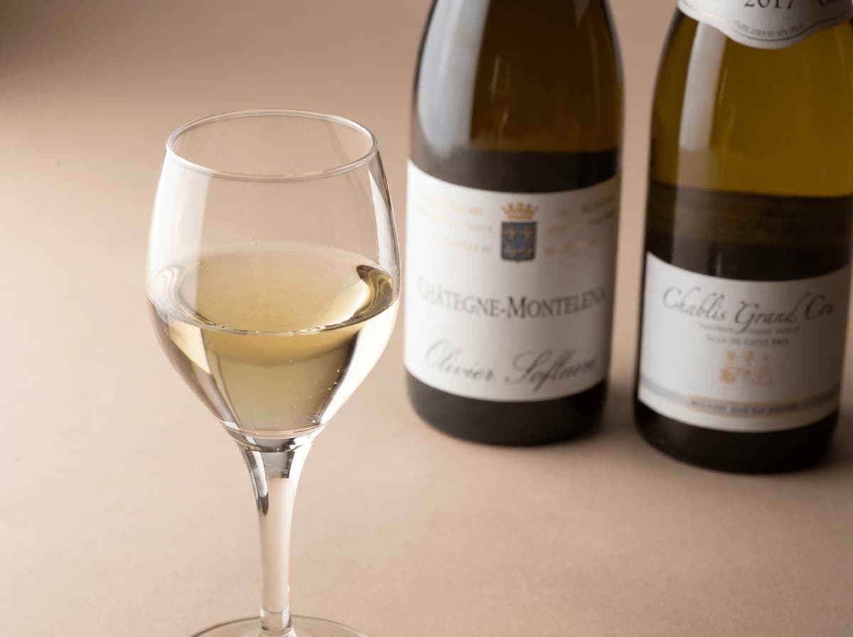 Wine glasses and two bottles of white wine