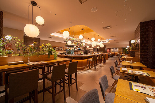 Ignite is a stylish and modern cafe and dining establishment. The interior features counter seats illuminated by warm-colored pendant lights and tables in calming tones.