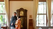 大時計の前で寄り添い合う和装の新郎新婦