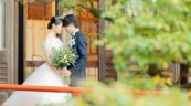 奈良ホテルの庭でおでこを合わせる新郎新婦